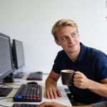 Developer utilizing scripts for optimizing web development hardware on a workstation.